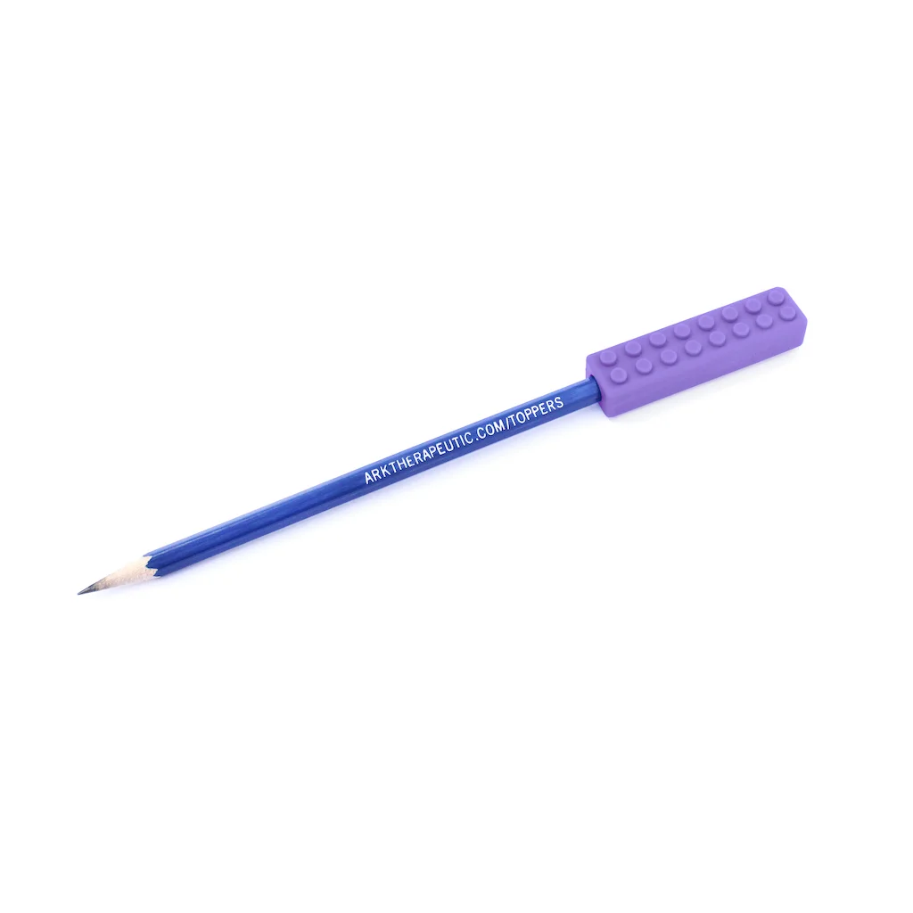 ARK Brick Stick pencil topper – child at school writing with focus and concentration through chewing